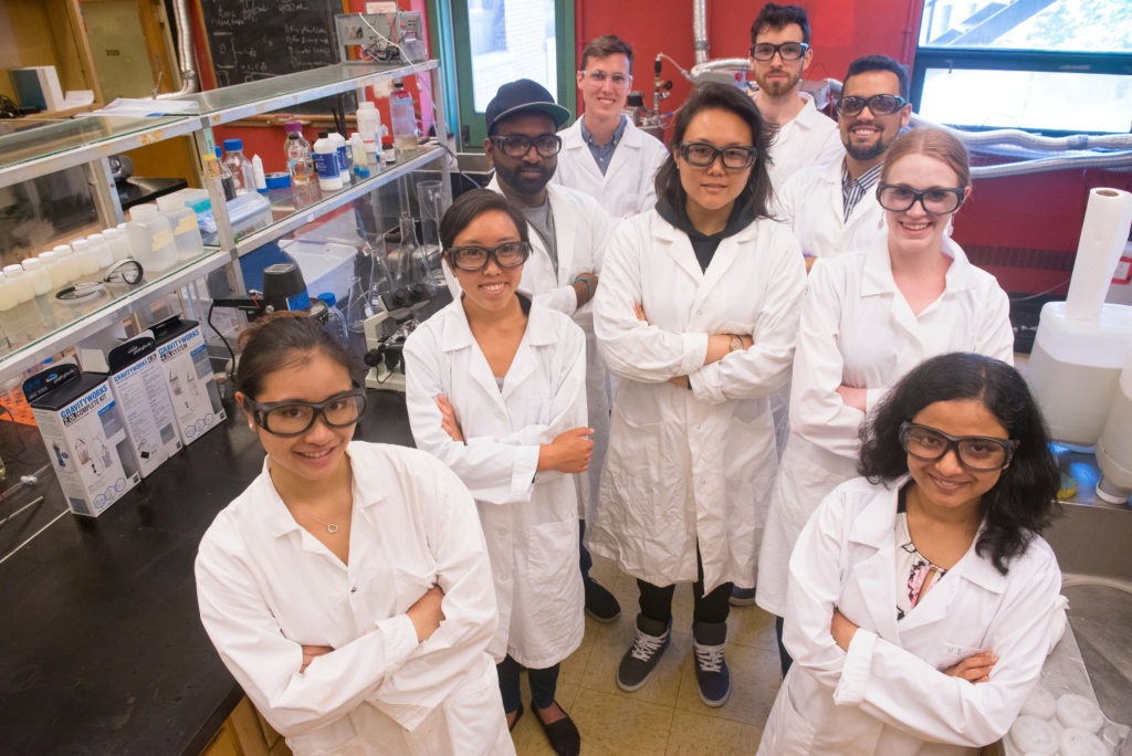 A group photo of the Genecis team in a lab